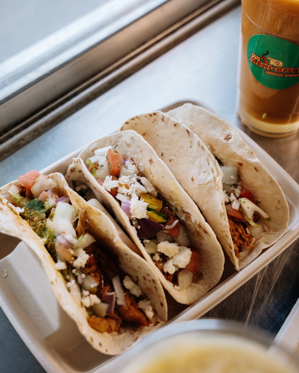 Three soft flour tacos with chicken tinga, onion, cilantro, pico and cotija